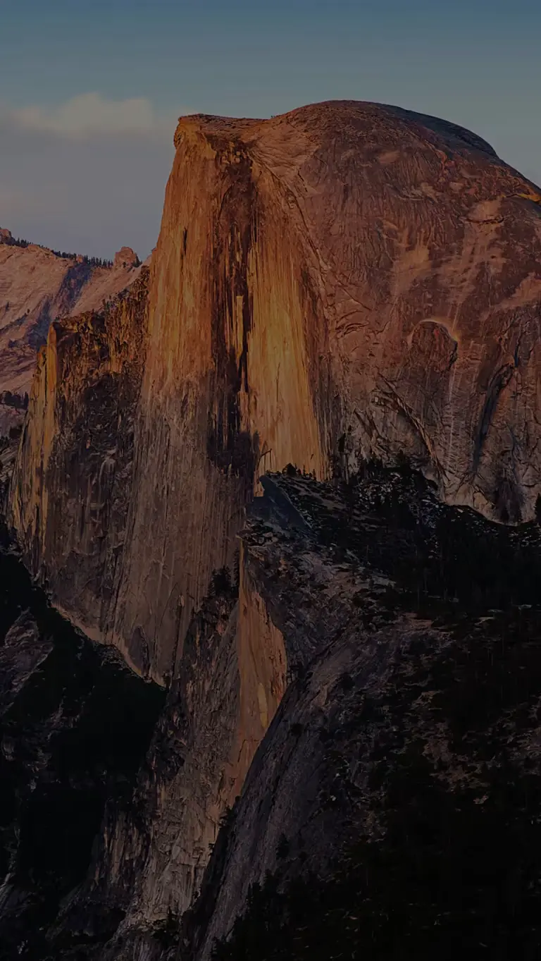 A vibrant sunset illuminates Half Dome in Yosemite National Park.