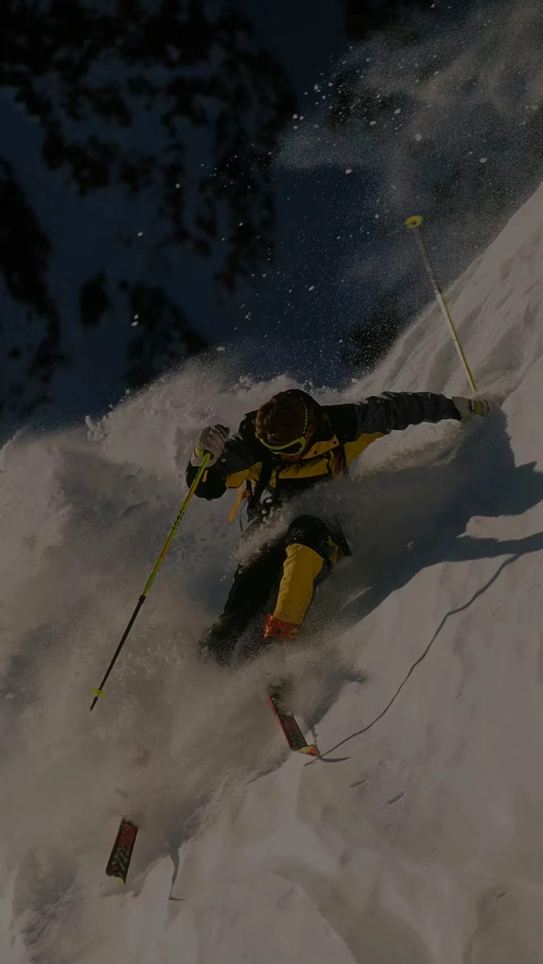 Professional skier, Scot Schmidt, makes a steep descent of a near vertical slope.
